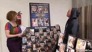 Sara Jay is sucking a big, black knob through a gloryhole and enjoying while riding it