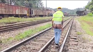 The workers were doing maintenance on a railway line, and the work was hard with a passive colleague in the midst of the tracks.