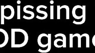 Nonchalant pissing in bed while playing COD game in phone