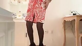 Gorgeous and lascivious Spanish trans girl with long legs cums in an orange dress, skirt and top, black heels, and lingerie