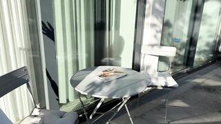 Wonderfully marvelous angel in a summer dress no panties on the balcony shows her tight hairless cunt to the neighbors
