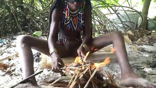 Marvelous tribe hotty making traditional jewelery next to a firecamp