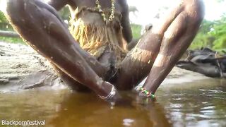 Hot slim African village woman bathing and teasing in a river