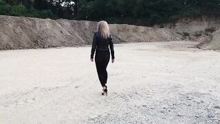 Grandma is walking around a gravel pit in tight leggings and high heels!