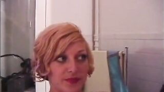 two golden-haired mistresses in latex pour hot candle wax on young slave girl