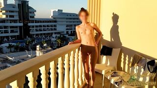 Naked girl on the balcony greets the morning