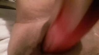 Taking giant pink sex-toy before daybed