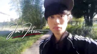 Freeballing in public, this twink walks outdoors commando, no underclothes beneath his black Adidas tracksuit, Campus sneakers, while out cruising