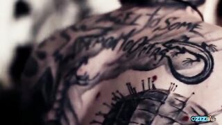 Initially, the tattoo is shown, followed by the striking prominence of large natural boobs.