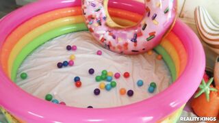 Pigtailed bimbo chick in minipool has giant fake boobs