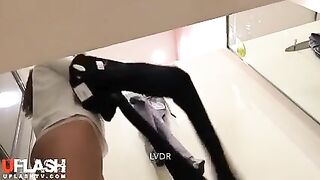 latina in changing Room looks right at camera