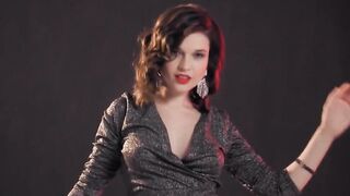 Astounding brunette in thigh high boots with high heels is posing and not fast getting nude