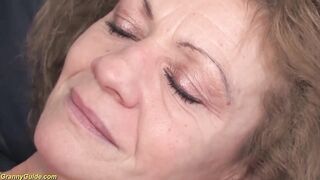 Aged golden-haired woman in erotic, red stockings and matching lingerie is having sex with a younger chap