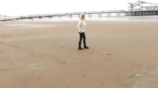 Busty golden-haired woman is gently rubbing her exceedingly curly cunt, in front of the camera