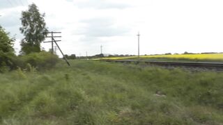 Naked in public. Woman without panties poses near train. Void urine public. Outdoor