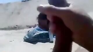 Lady takes pics of stud flashing on the beach