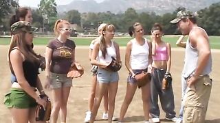 Trainer shows 2 female athletes how to properly handle a big bat
