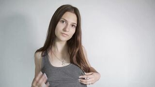 Sweet teen brunette is posing and teasing in front of the camera, just for enjoyment