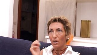 Mature golden-haired woman with short hair is getting nailed on the daybed, in the living room