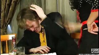 Older waitress serves a visitor