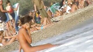 Sexy beach nudist beauty spied talking on phone near water