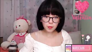 Excited teen with braces and glasses is showing her tongue on web camera, late at night